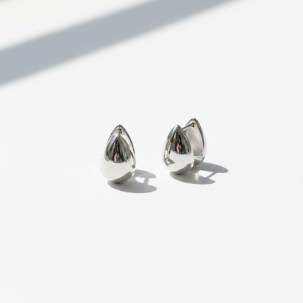 Silver Teardrop Hoop Earrings White Background Natural Light