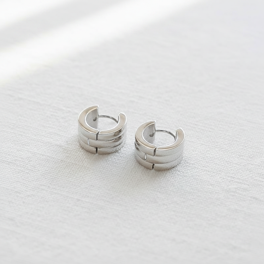 Silver Triple Band Huggie Hoop White Background Natural Light
